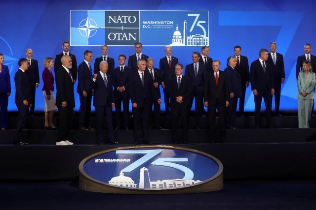NATO Secretary General Jens Stoltenberg, U.S. President Joe Biden, Britain's Prime Minister Keir Starmer, German Chancellor Olaf Scholz, France's President Emmanuel Macron, Italy's Prime Minister Giorgia Meloni, Slovakia's President Peter Pellegrini and Albania's Prime Minister Edi Rama stand together as they attend NATO's 75th anniversary summit in Washington, U.S., July 10, 2024 (Photo: REUTERS/Yves Herman).