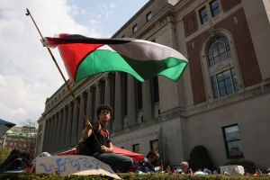 A student waves a flag during a march on Columbia University campus in support of a protest encampment supporting Palestinians, despite a 2pm deadline issued by university officials to disband or face suspension, during the ongoing conflict between Israel and the Palestinian Islamist group Hamas, in New York City, U.S., April 29, 2024. Photo: Reuters by Caitlin Ochs