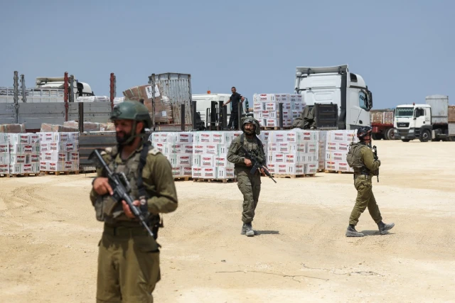 Israeli soldiers secure humanitarian aid, amid the ongoing conflict in Gaza between Israel and the Palestinian Islamist group Hamas, near the Erez Crossing point in northern Gaza, May 1, 2024 (Photo: EUTERS/Ronen Zvulun).