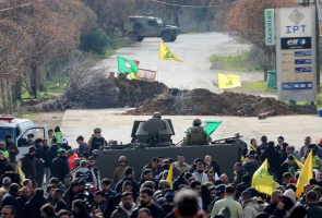 Locals hold Hezbollah flags as they gather in Burj al-Muluk, near the southern Lebanese village of Kfar Kila, where Israeli forces remain on the ground after the ceasefire in Lebanon was extended by 3 weeks, January 26, 2025. REUTERS/Karamallah Daher