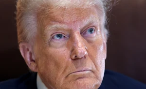 U.S. President Donald Trump looks up while speaking to reporters from his office aboard Air Force One en route to New Orleans to attend the Super Bowl, February 9, 2025. REUTERS/Kevin Lamarque