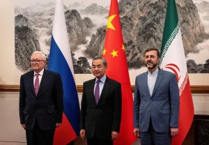 Chinese Foreign Minister Wang Yi stands with Russian Deputy Foreign Minister Sergey Ryabkov, and Iranian Deputy Foreign Minister Kazem Gharibabadi, before a meeting regarding the Iranian nuclear issue at Diaoyutai State Guest House on March 14, 2025, in Beijing, China. Photo: via Reuters