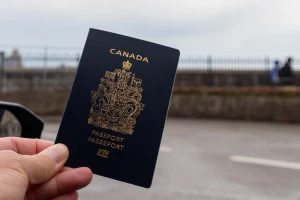 A passenger’s hand holds up a Canadian passport , Canada, 15 Mar 2025 Photo: Reuters Connect