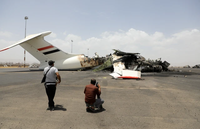 Members of the media take pictures of a destroyed plane at Sanaa International Airport, in the aftermath of an Israeli airstrike, in Sanaa, Yemen, May 7, 2025. REUTERS/Khaled Abdullah