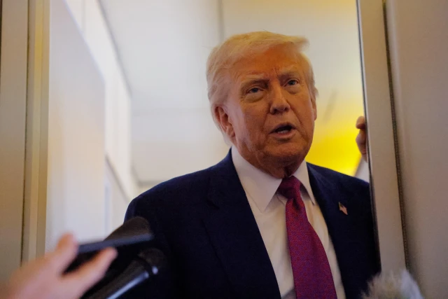 U.S. President Donald Trump talks to reporters aboard Air Force One, en-route to Abu Dhabi, United Arab Emirates, May 15, 2025. REUTERS/Brian Snyder