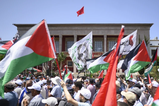 Palestinian and Moroccan flags wave during a national demonstration to denounce the starvation crisis in Gaza, in front of the Moroccan Parliament in Rabat Morocco on July 20 2025. Photo: Reuters