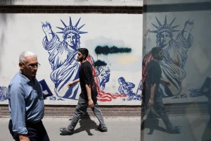 People walk past an anti-U.S. mural on a street in Tehran, Iran, May 11, 2025