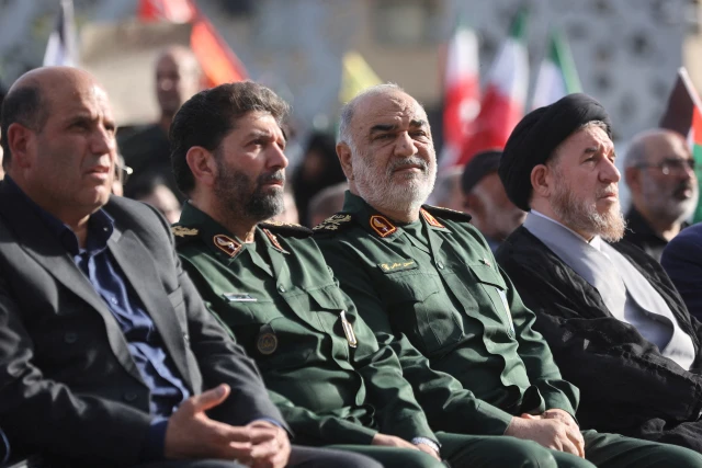 IRGC commander-in-chief Hossein Salami (center right) attends a public event with other Iranian officials in Tehran, Iran, May 15, 2025. (Photo: Majid Asgaripour/WANA via Reuters)