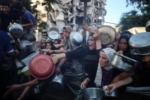 Palestinians gather at a food distribution point in Gaza City, on July 20, 2025. (Photo by Reuters/Majdi Fathi/NurPhoto)