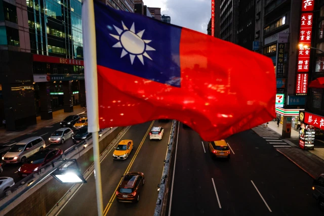 A Taiwan flag can be seen on an overpass ahead of National Day celebrations in Taipei, Taiwan, October 8, 2025. REUTERS/Ann Wang