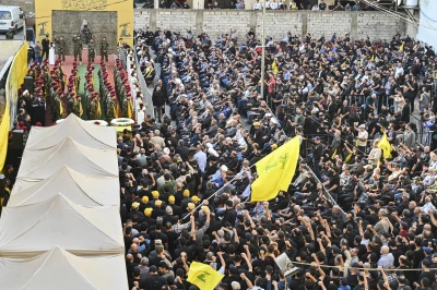 Hezbollah members carry a coffin while chanting political slogans during the funeral procession in Beirut, Lebanon, on November 24, 2025. (Photo via Reuters).