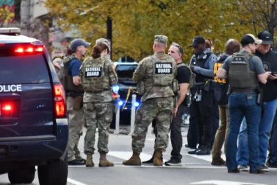 National Guard and investigative personnel talk in Washington on Nov. 26, 2025, near the site of a shooting incident in which two West Virginia National Guard members were shot earlier in the day near the White House. (Photo: via Reuters)
