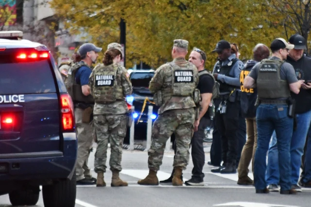 National Guard and investigative personnel talk in Washington on Nov. 26, 2025, near the site of a shooting incident in which two West Virginia National Guard members were shot earlier in the day near the White House. (Photo: via Reuters)