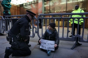 Swedish activist Greta Thunberg speaks to a police officer during a pro-Palestinian protest as she holds a sign that says she supports prisoners linked to Palestine Action, an organisation which the British government has proscribed as a terrorist group, in London, Britain, December 23, 2025. (Photo: Prisoners for Palestine/Handout via Reuters)