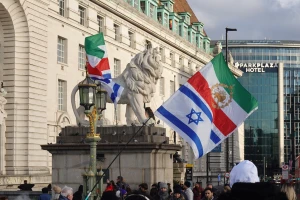 Pre-revolutionary Iranian flags flown alongside Israeli flags by demonstrators in London, England, United Kingdom, on December 24, 2025. The joint display represents a growing solidarity between segments of the Iranian diaspora and the state of Israel following military escalations between Israel and the Islamic Republic in mid-2025. Photo by Michael Nguyen/NurPhoto via Reuters.