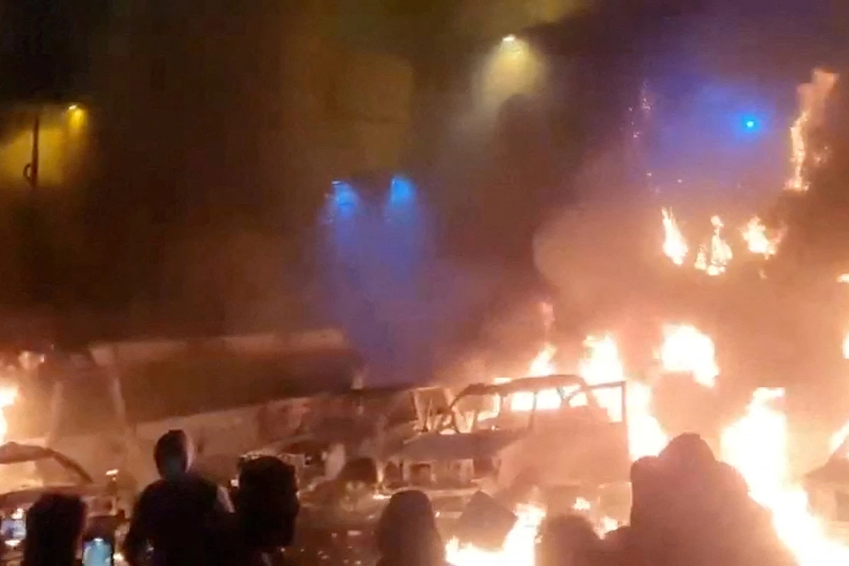 Protesters gather as vehicles burn, amid evolving anti-government unrest, in Tehran, Iran, in this screen grab obtained from a social media video released on January 9, 2026. Social Media/via REUTERS