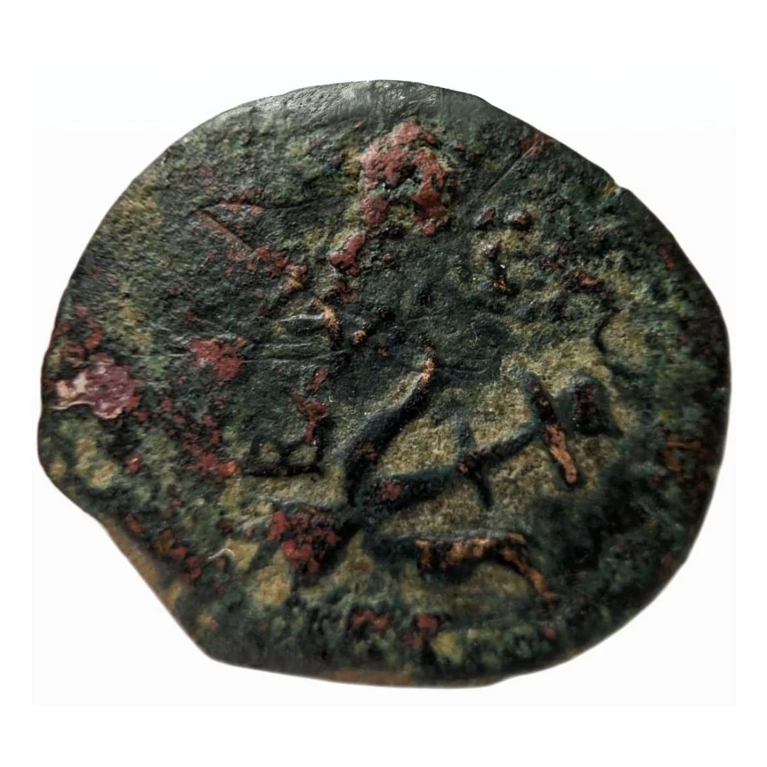 Reverse of a 2000 years old widow's mite coin, showing an anchor, found by a 11 years old child, February, 2024
(photo: Israel Antiquities Authority)