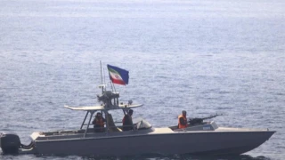 An Iranian navy boat of the Islamic Revolutionary Guard Corps operates near U.S. patrol coastal ship in the Strait of Hormuz, June 20, 2022. (Photo: U.S. Navy)