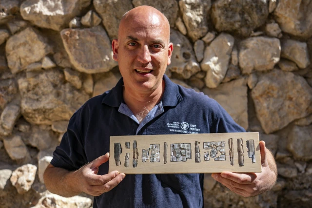 Dr. Yiftah Shalev of the Israel Antiquities Authority holds pieces of ivory decorations, Yaniv Berman, Israel Antiquities Authority