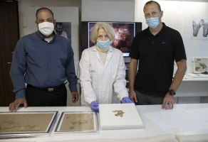 Raz Frohlich, Director General of the Ministry of Culture and Sports, Tanya Bitler, Scroll Conservationist at the Israel Antiquities Authority and Avi Cohen, the Director General of the Ministry of Jerusalem Affairs and Heritage, examining the discovered scroll fragments. (Photo: Shai Halevi/Israel Antiquities Authority)