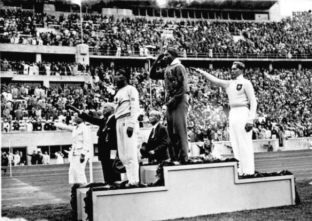 American Jesse Owens standing on the winners' podium after receiving the gold medal at the 1936 Olympics in Berlin, Germany (Photo: German Federal Archives via Wikimedia Commons)