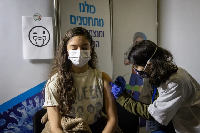 Young Israelis receives a Covid-19 vaccine injection, at Clalit Covid-19 vaccination center in Jerusalem, on February 4, 2021. Photo by Yonatan Sindel/Flash90