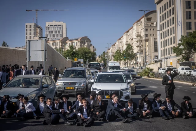 Ultra-Orthodox Jews block a road in a protest against the drafting of ultra-Orthodox Jews to the Israeli army, outside the Supreme Court in Jerusalem, June 2, 2024. (Photo: Chaim Goldberg/Flash90)