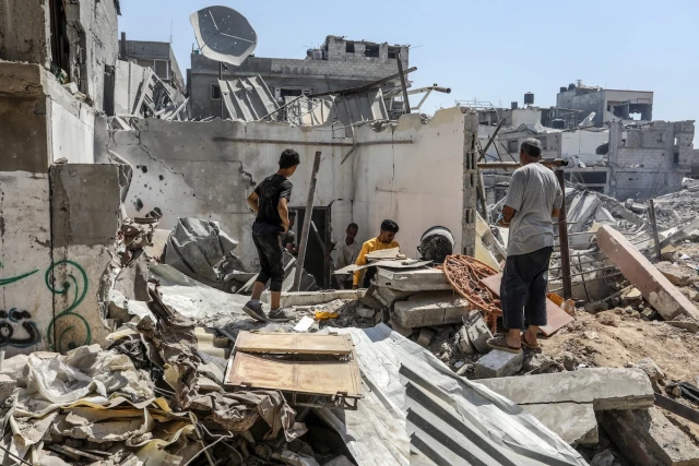 Palestinians seen near the destruction after the Israeli army withdrew its forces in east of Bureij camp in the central Gaza Strip, on June 12, 2024. Photo by Abed Rahim Khatib/Flash90