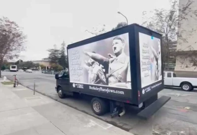 A truck displaying an image of Hitler giving a Nazi salute, with the caption “All in favor of banning Jews, raise your right hand” (Credit: Accuracy in Media)