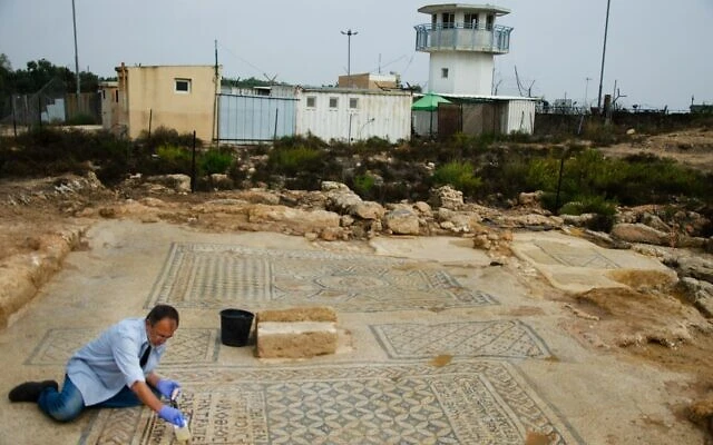 An Israel Antiquities Authority conservationist works on the 'Jesus' mosaic excavated at a prison in Megiddo in northern Israel, part of a structure from the third or fourth century that may be one of the earliest Christian churches. (Yoli Schwartz/IAA)