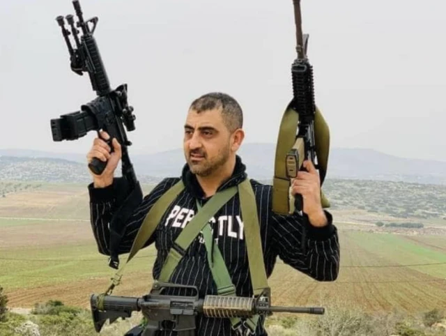 Palestinian doctor, Abdullah Abu Tin, who was reportedly a member of the Al-Aqsa Martyrs Brigades, is seen holding several assault rifles in an undated photo circulated online after his death during a clash with IDF soldiers, Oct. 14, 2022. (Photo: Twitter)