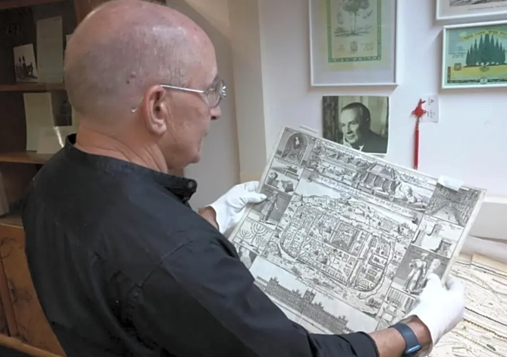 A researcher holds a drawing from the Umansky Collection (Photo: Haifa University)