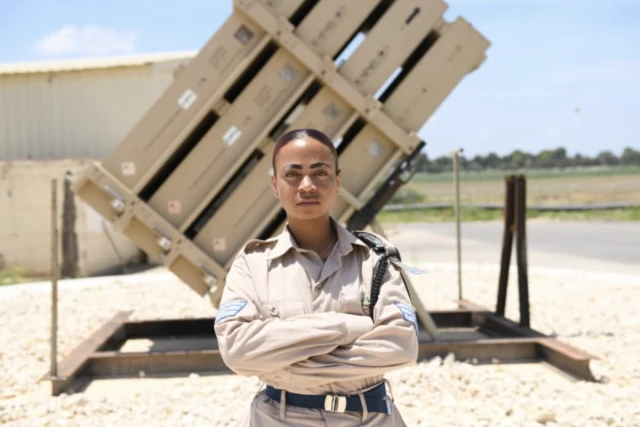 Llilaq Logan in front of Iron Dome battery. (Photo: IDF Spokesperson’s Office)