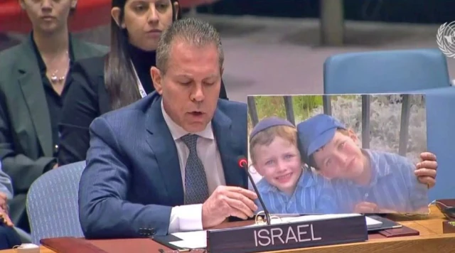 Israel's Ambassador Gilad Erdan, holds picture of Israeli children murdered in a recent terror attack, during a speech at UN Security Council, Feb. 20, 2023. (Photo: Israel's Mission to the UN)