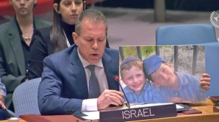 Israel's Ambassador Gilad Erdan, holds picture of Israeli children murdered in a recent terror attack, during a speech at UN Security Council, Feb. 20, 2023. (Photo: Israel's Mission to the UN)