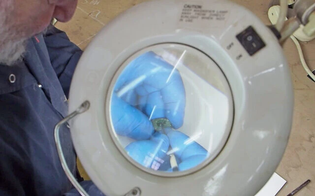 Conservationist Yosef Bukengolts cleaning the scarab seal in the Israel Antiquities Authority Laboratories. Photo: Assaf Peretz, Israel Antiquities Authority.