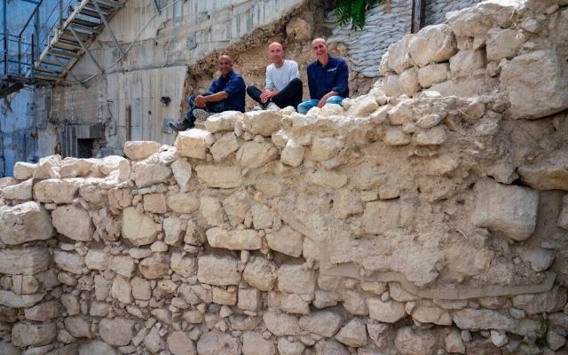 The excavation directors sitting on the exposed section of the first Temple-era protective wall on Jerusalem's eastern perimeter. (Photo: Yaniv Berman/Israel Antiquities Authority)