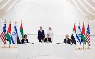 L-R: Energy and Water Resources Minister Karine Elharrar, UAE Climate Change Minister Mariam Almheiri and Jordan Water and Irrigation Minister Mohammed Al-Najjar sign a water agreement at a Dubai Expo event on November 22, 2021, as US Climate Envoy John Kerry and UAE Crown Prince Mohammed bin Zayed look on. (UAE Foreign Ministry/Twitter)