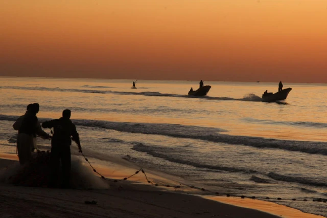 Palestinian fishermen are seen working at sunrise at the port of Gaza City. Fishing is a crucial livelihood for many Palestinians living in the impoverished territory. february 11, 2010. Photo by Wissam Nassar/FLASH90