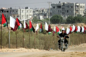 Member of Hamas security forces rides a motorcycle next to Palestinian and Qatar flags during preparations for the celebratory reception of Qatar's Emir Sheik Hamad bin Khalifa al-Thani, in Khan Younis in the southern Gaza Strip on October 22, 2012. The emir of pro-Western Qatar will become the first head of state to enter the blockaded Gaza Strip on Tuesday, in a high-profile visit breaking the isolation of the Iranian-backed Islamist movement Hamas that seized power in 2007. Photo by Abed Rahim Khatib / Flash 90