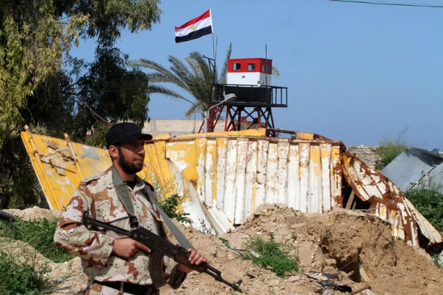 A member of Palestinian security forces stands guard on the border between Egypt and southern Gaza Strip, in Rafah, on March 5, 2015. Gaza's border crossings will be reopened once control of them is handed over to the Palestinian Authority, Egypt's Ambassador to the Palestinian Authority (PA) Wael Attia said. Photo by Abed Rahim Khatib/Flash90
