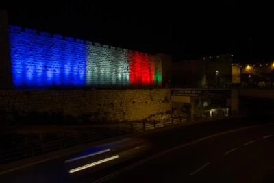 The walls of Jerusalem's Old City are lit in red, white and blue, resembling the colours of the French flag on November 15, 2015, in solidarity with Paris, and in tribute of the victims killed in last night's terror attacks in Paris, France. Photo by Yonatan Sindel/Flash90
