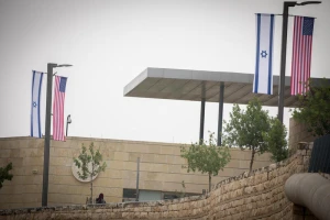 Jerusalem municipality worker hangs an American and Israeli flags near the US consulate in Jerusalem on May 7, 2018. Photo by Yonatan Sindel/Flash90