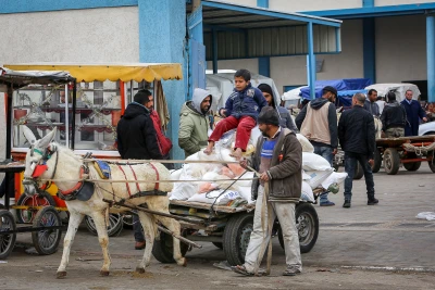 Palestinians receive food aid at a United Nations distribution center (UNRWA) in the southern Gaza Strip town of Rafah, on January 13, 2020. Photo by Abed Rahim Khatib/Flash90