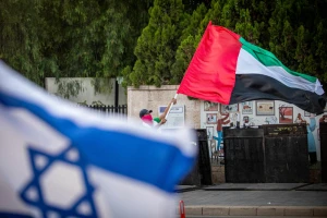 A man waves a giant United Arab Emirates flag outside the Prime Minister's official residence in Jerusalem on August 19, 2020. Photo by Yonatan Sindel/Flash90