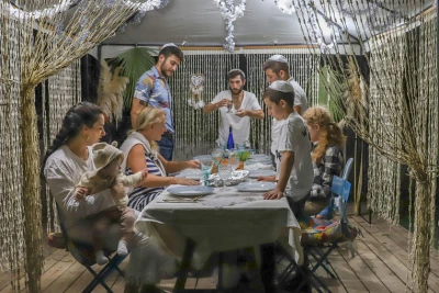 A Jewish family sitting in a Sukkah during the Jewish holiday of Sukkot, in Moshav Yashresh, on October 2, 2020. Photo by Yossi Aloni/Flash90
