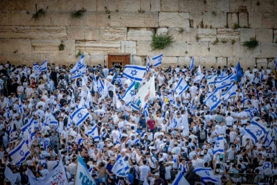 Jews hold Israeli flags as they dance at the Western Wall in Jerusalem's Old City, during Jerusalem Day celebrations, May 18, 2023. Photo by Yonatan Sindel/Flash90