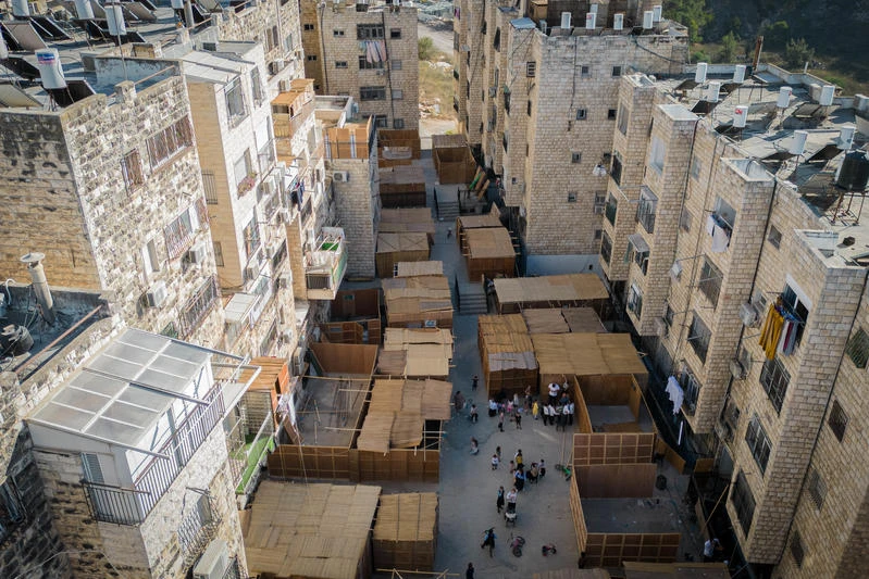 A street full of "Sukkot" (temporary dwelling), in the religious neighborhood of Sorotzkin in Jerusalem on September 27, 2023. Sukkot commemorates the Israelites 40 years of wandering in the desert and a decorated hut or tabernacle (sukka) is erected outside religious households as a sign of temporary shelter. Photo by Chaim Goldberg/ FLASH90.