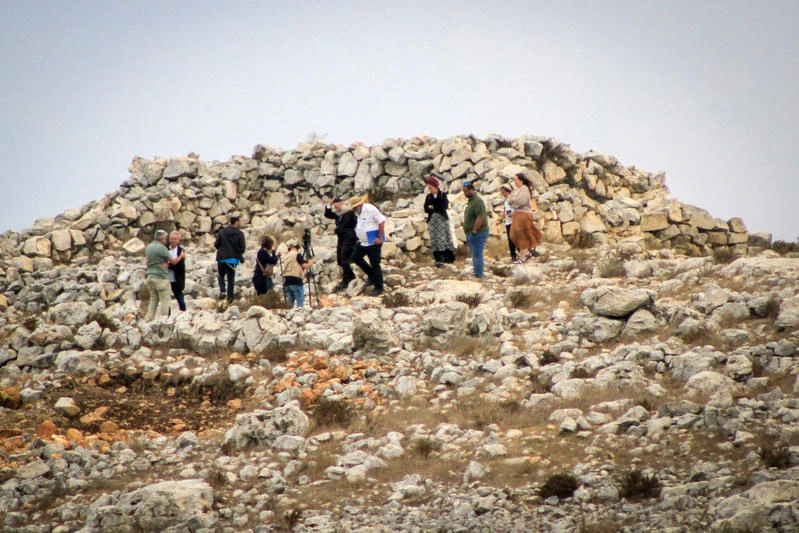 Jewish settlers raise Israeli flags on Mount Ebal in the West Bank city of Nablus during a visit to the altar of Yehoshua Ben Nun during the Jewish holiday of Sukkot, on October 02, 2023. Photo by Nasser Ishtayeh/Flash90