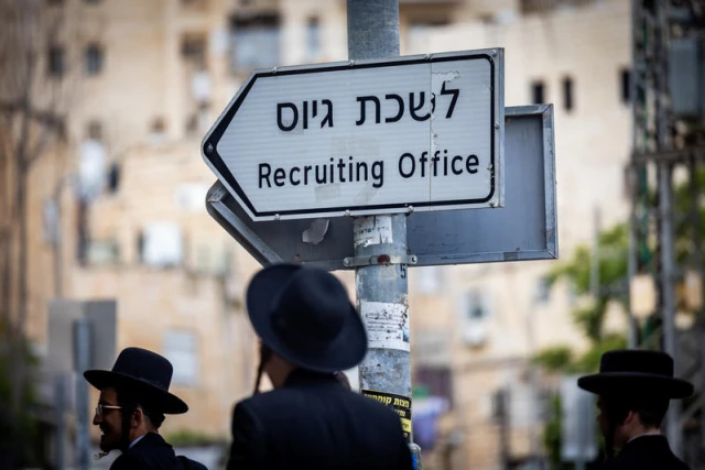 Ultra orthodox jewish men near a sign reading "army recruitment office" during a protest against the drafting of Ultra orthodox jews to the Israeli army outside the army recrutiment office in Jerusalem, May 1, 2024. Photo by Yonatan Sindel/Flash9